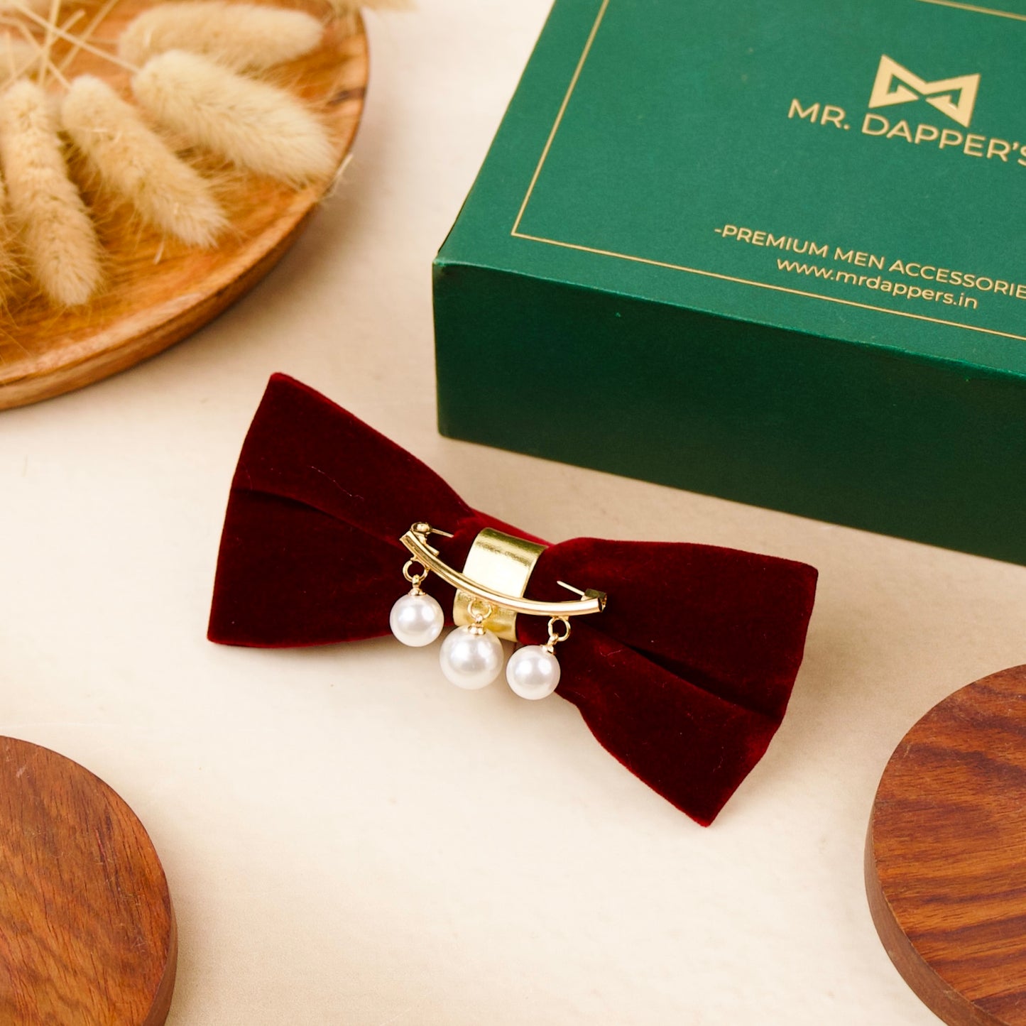 A red velvet bow tie adorned with elegant pearls, showcasing a sophisticated and stylish accessory for formal attire.