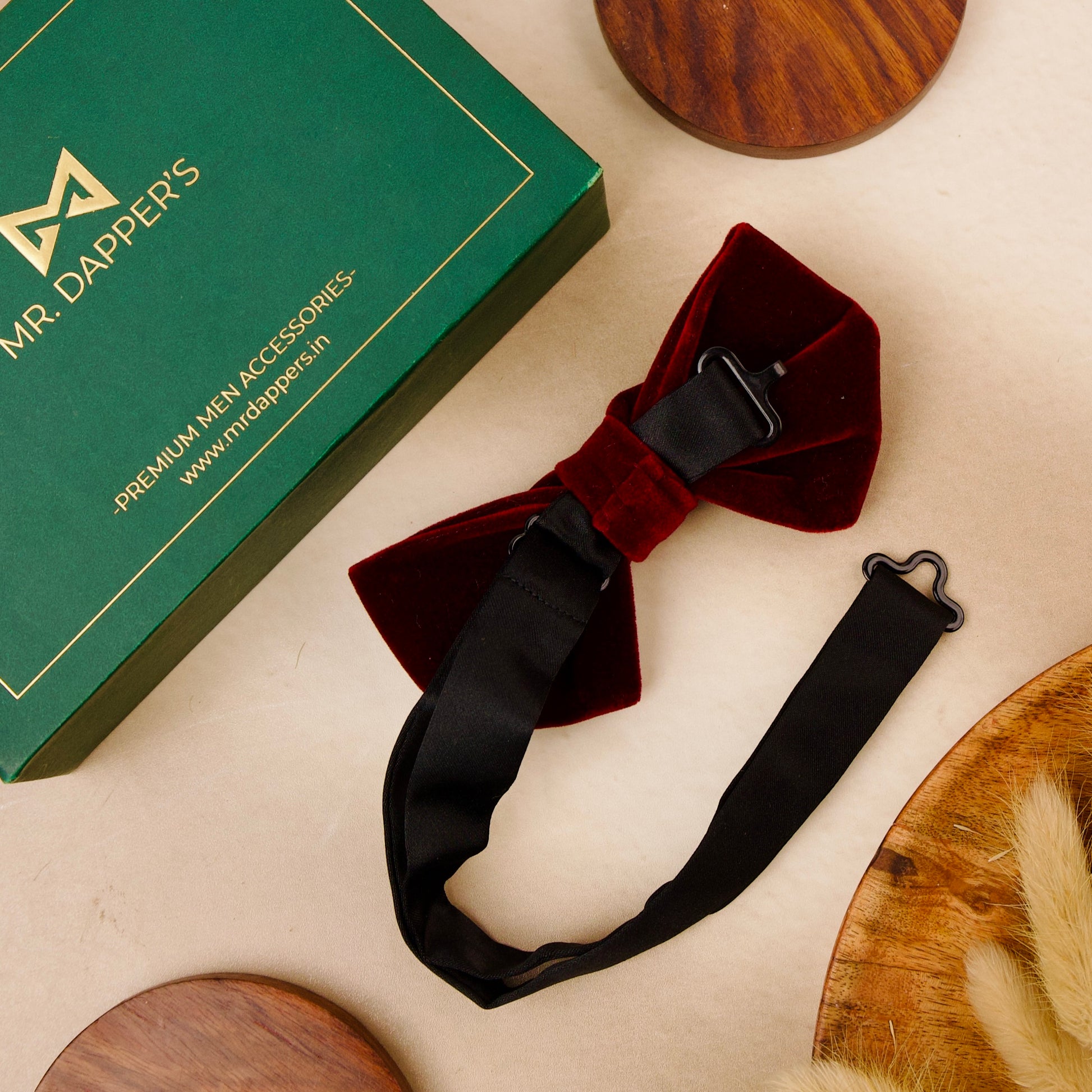 A red velvet bow tie adorned with elegant pearls, showcasing a sophisticated and stylish accessory for formal attire.