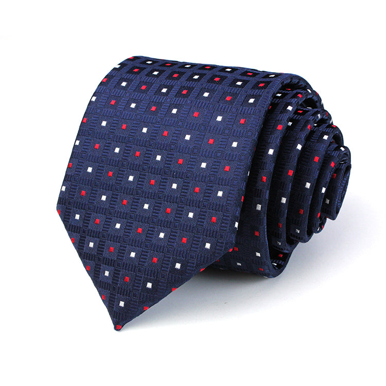 A navy necktie adorned with red and white polka dots, showcasing a classic and stylish design suitable for formal occasions.