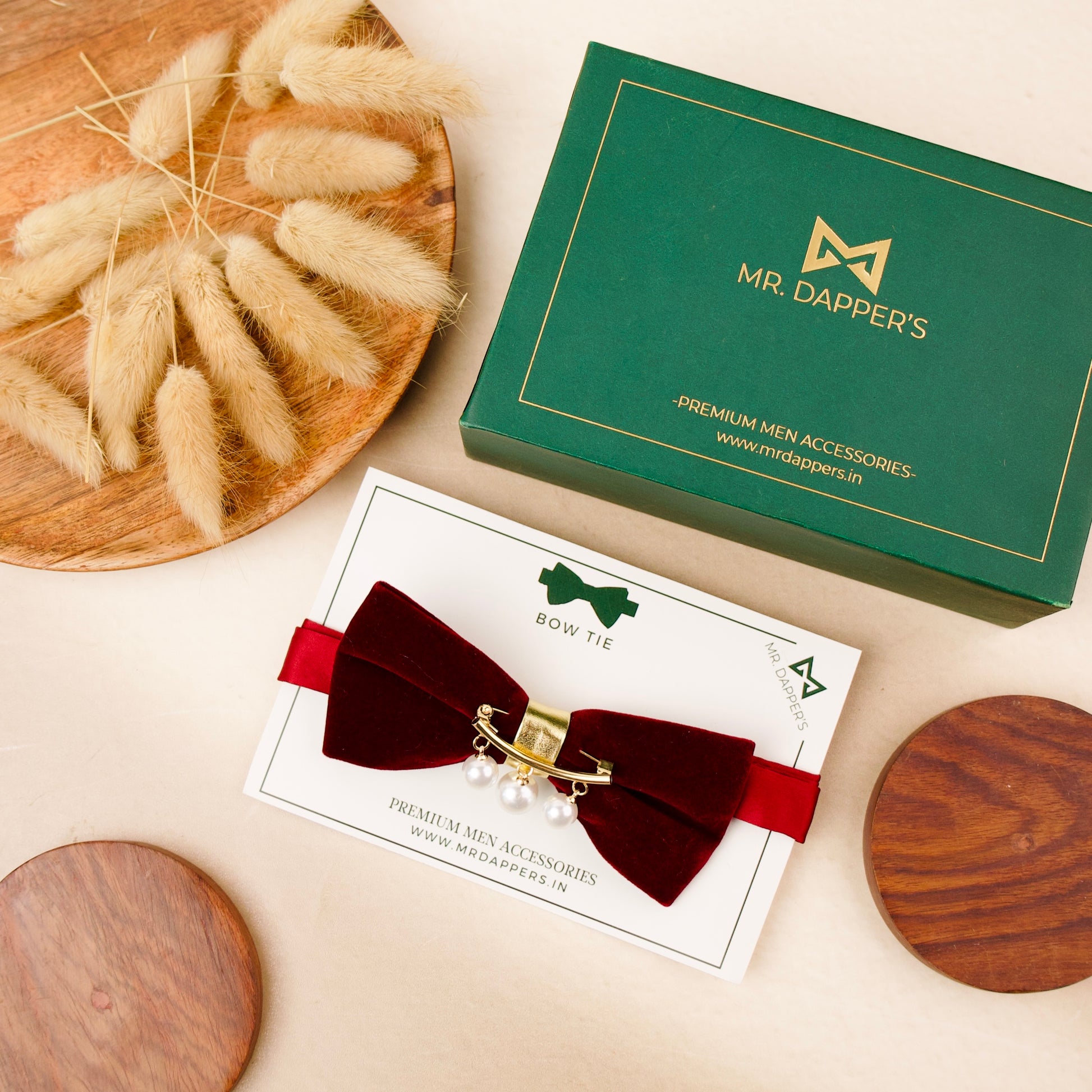 A red velvet bow tie adorned with elegant pearls, showcasing a sophisticated and stylish accessory for formal attire.