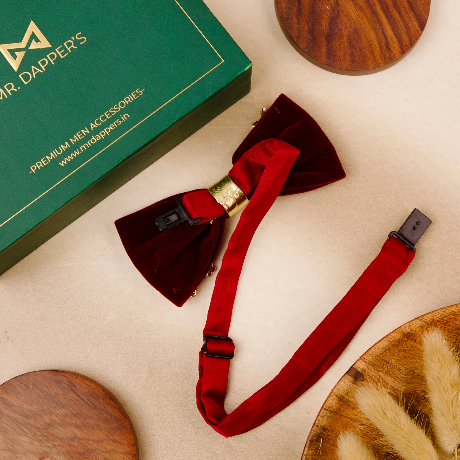 A stylish bow tie placed next to an elegant box of mr dapper's perfect for a special occasion.