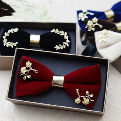 A stylish bow tie placed next to an elegant box of assorted chocolates, perfect for a special occasion.