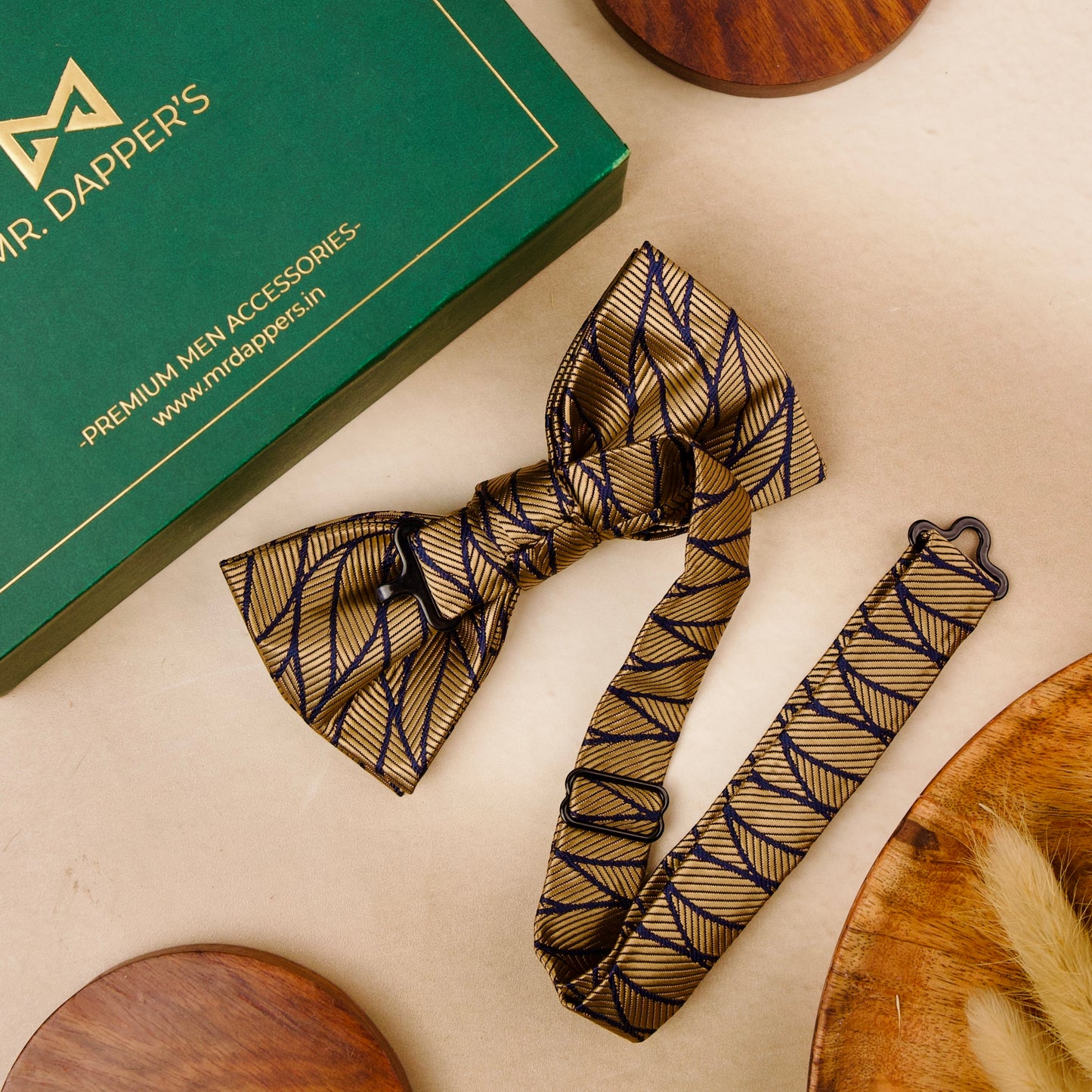 A stylish bow tie and a small wooden bowl are placed on a table, highlighting a unique combination of sophistication and simplicity.