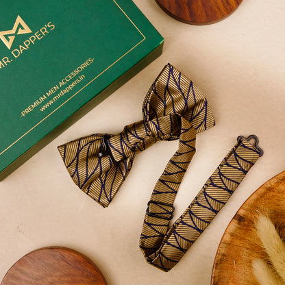 A stylish bow tie and a small wooden bowl are placed on a table, highlighting a unique combination of sophistication and simplicity.