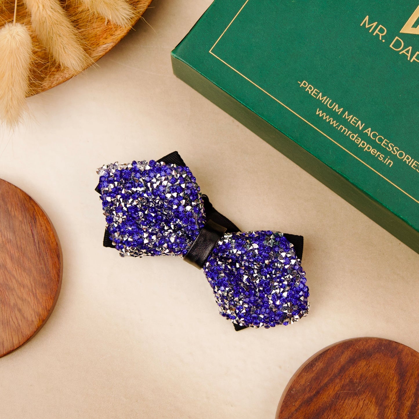 A blue bow tie adorned with shimmering silver sequins, adding a touch of elegance and sparkle.