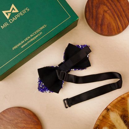 A blue bow tie adorned with shimmering silver sequins, adding a touch of elegance and sparkle.