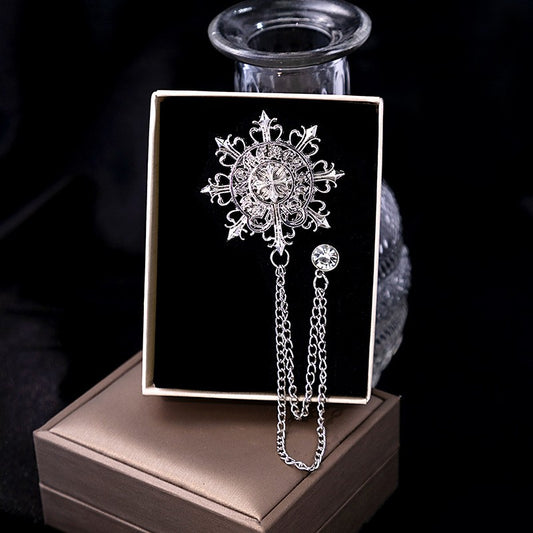 "Men’s snowflake brooch with chain detail, handcrafted and polished silver"